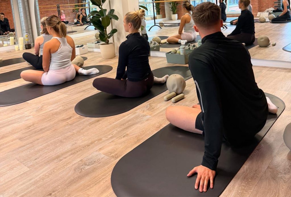 A group of people doing mat-based pilates